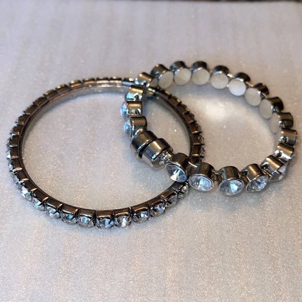 Two clear rhinestone bracelets. 